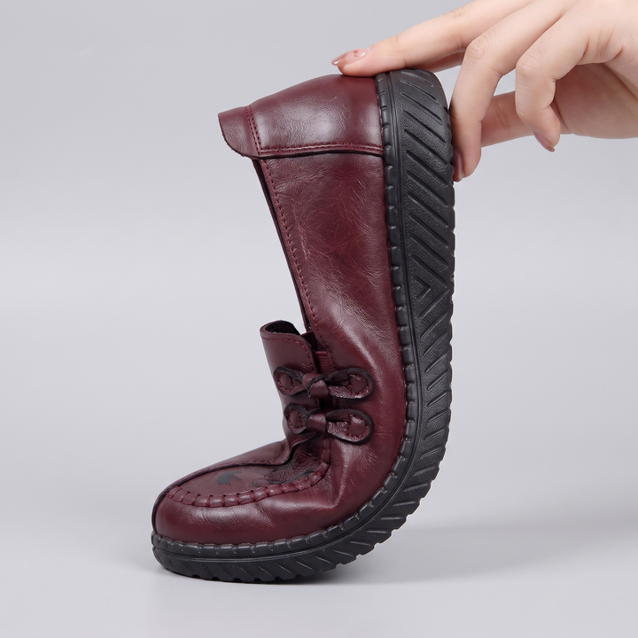 Andrea loafer flexed by hand showing the soft flexible sole